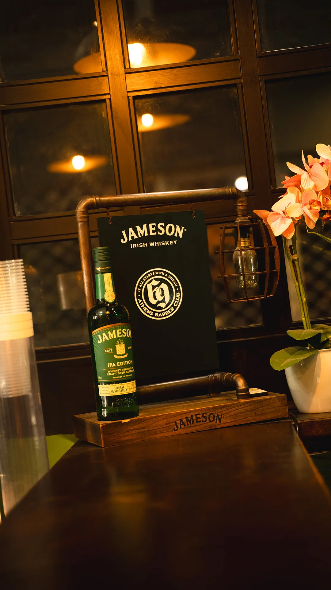Jameson whiskey display on a bar counter in warm light
